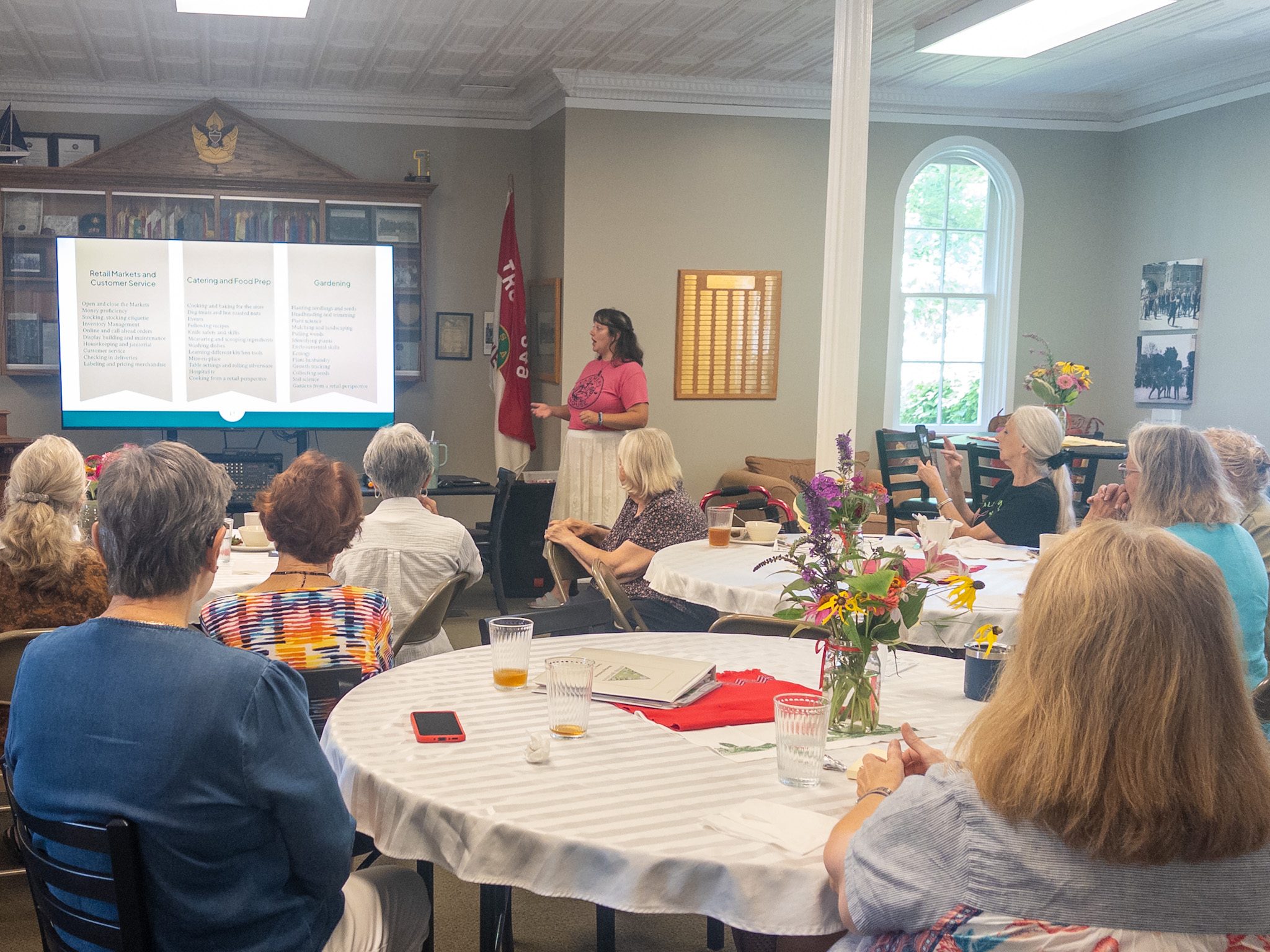 photo by megan jantos
Above, Madi DeShezo, garden manager and horticultural educator at The Farmer’s House, explains the organization’s vocational training programs during the Weston Garden Club’s monthly meeting July 8 at Weston United Methodist Church. The programs help people with intellectual and developmental disabilities build practical and employment skills through gardening, food preparation and retail operations.