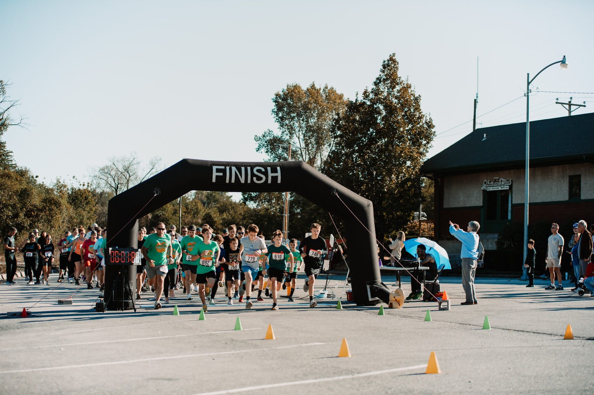 Photos by Hilary Buford
Runners take off beneath the finish-line arch during the Weston Bluffs Trail 5K and 10K on Oct. 17. The event began in 2018 as an untimed costume run and later added chip-timed 5K and 10K races.