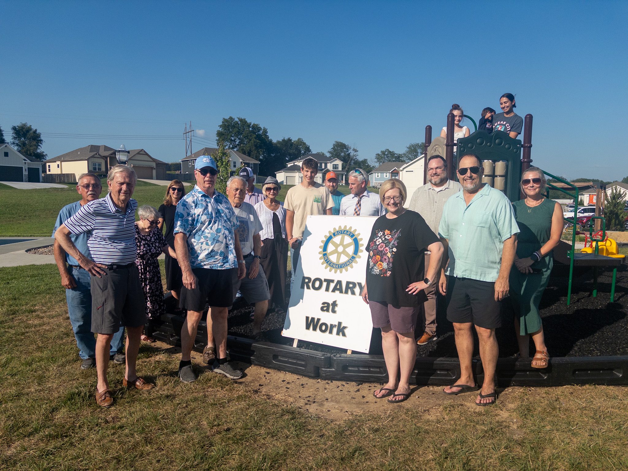 photo by megan jantos
Members of the Weston Rotary Club, Weston Park Board and community gather July 15 at Orchard Hill Park to celebrate the installation of new playground equipment. Rotary provided funding and volunteer labor for the project, which completed an element removed from the park’s original redevelopment plan because of limited funding.