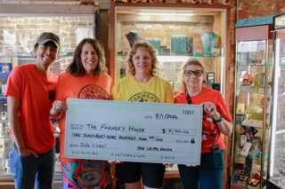 Organizers and representatives of The Farmer’s House display a $1,900 donation from the fifth annual “Out the Front to the Back” 0.08K Run on Saturday, Aug. 1, at The Celtic Ranch in Weston.