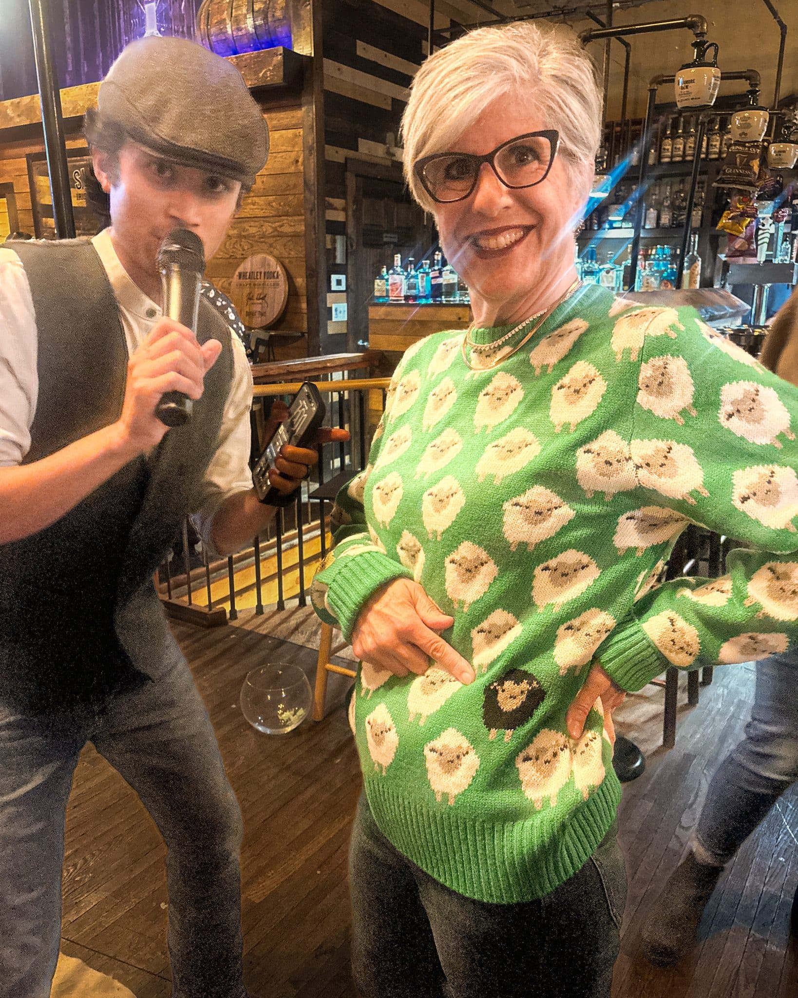 PHOTO BY MEGAN JANTOS
Renz Pros, left, introduces Julie Jones as she models a sheep-patterned sweater during the Celtic Ranch’s annual Celtic Couture Fall Fashion Show on Sept. 23 in Weston.